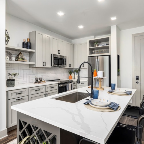 Kitchen with large island, wine rack, pantry, and stainless steel appliances Kitchen with large island, wine rack, pantry, and stainless steel appliances