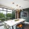 large co working table with a tv and floor to ceiling windows in the clubhouse 