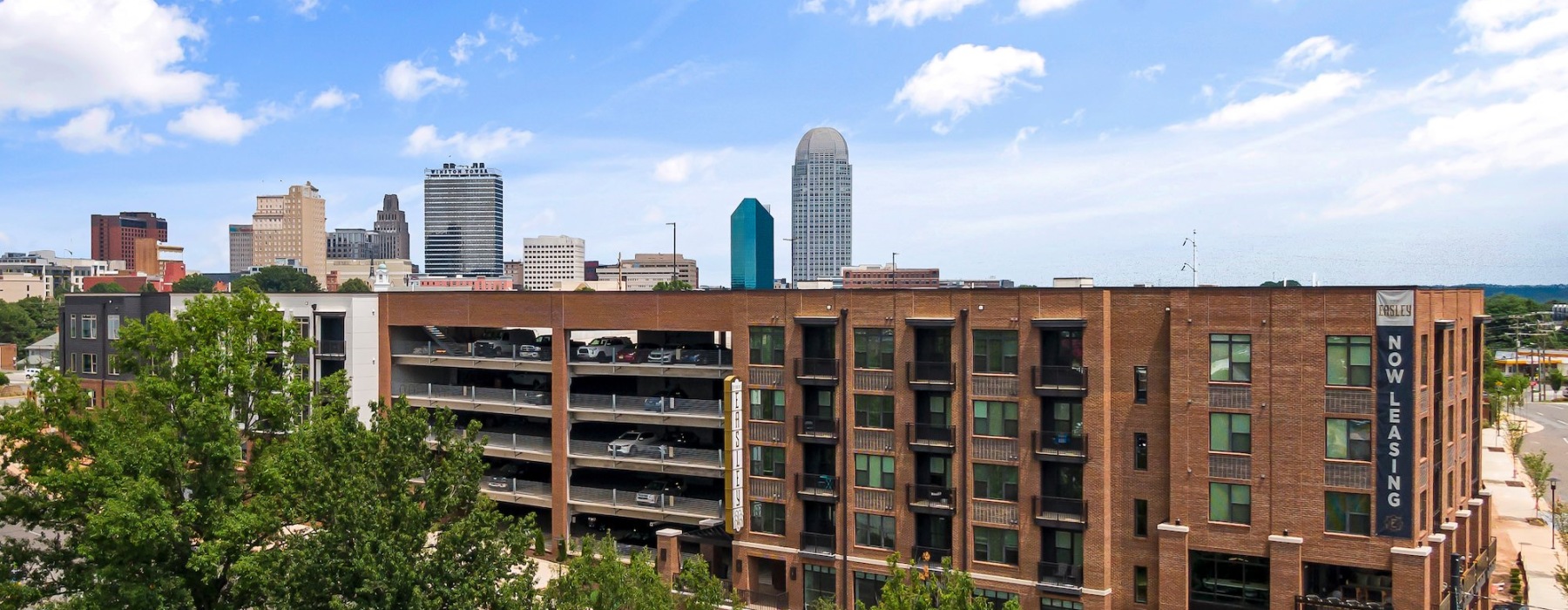 Drone shot of The Easley with downtown Winston-Salem in the background